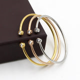 Pulsera abierta dorada con cristales gemelos