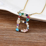 Collar con iniciales y piedras preciosas doradas de 18 quilates